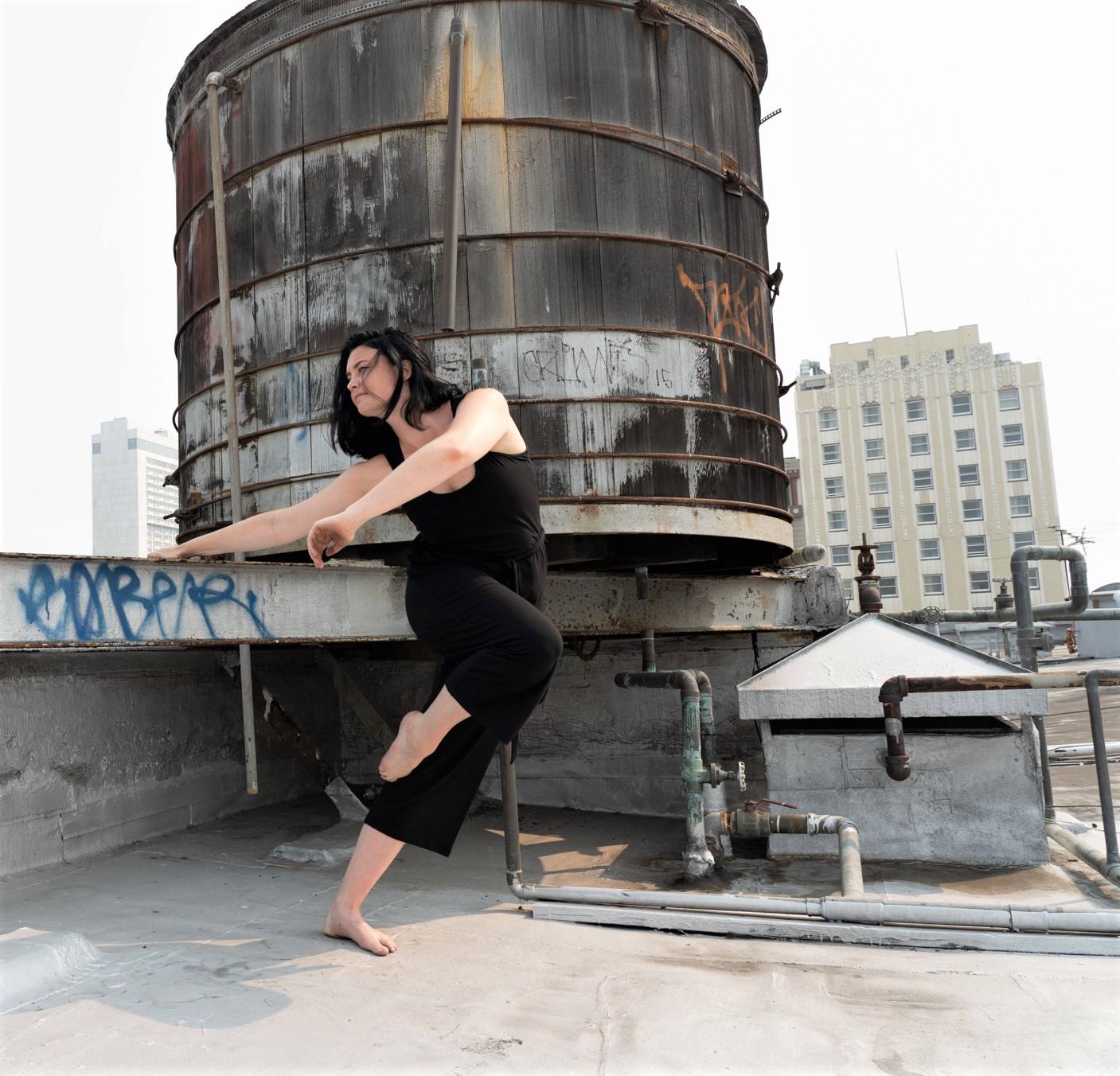Jenna Valez dancing in front of a water tower
