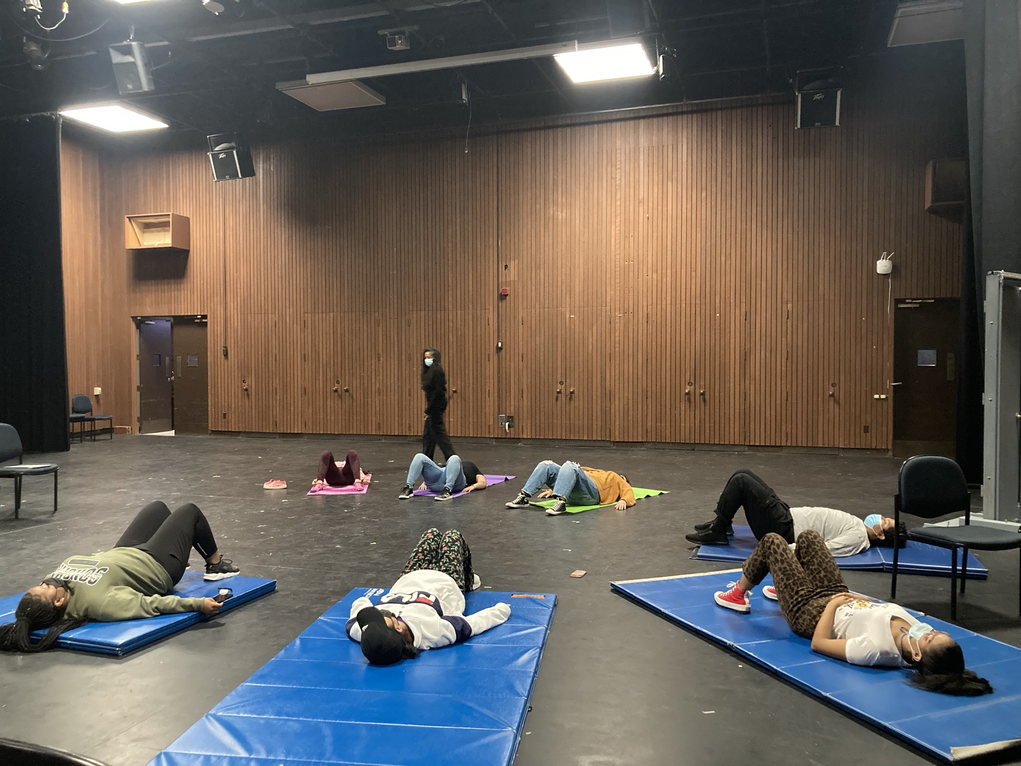 Students laying down on mats