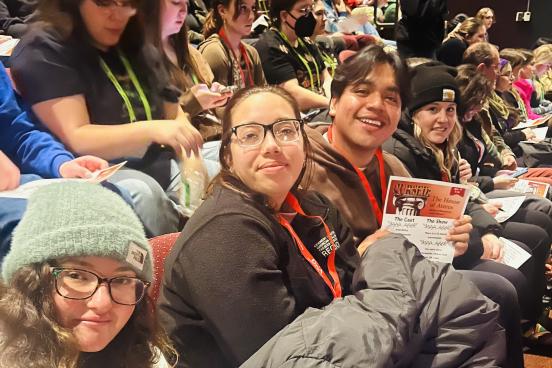 Students sitting in theatre seats