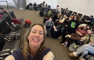 Kristen Daley taking a selfie with dancers in the airport