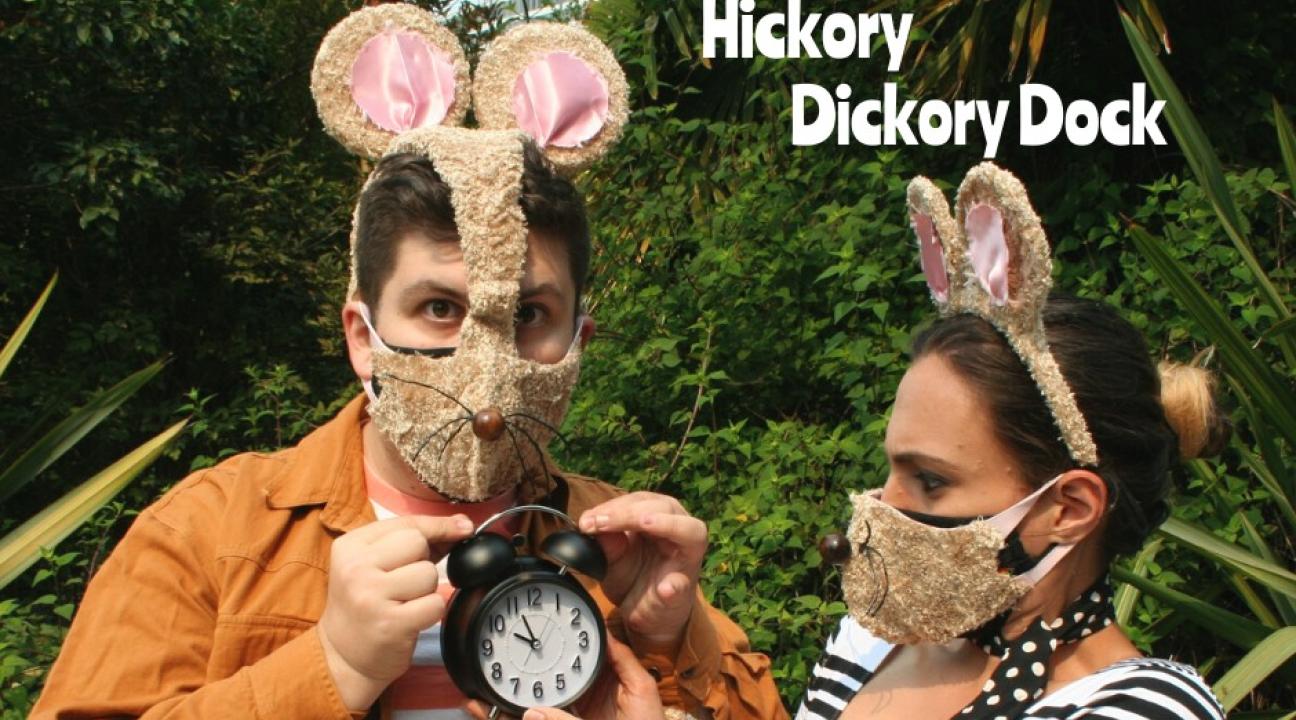 Hickory Dickory Dock with two actors dressed in mouse costumes and one holding a clock