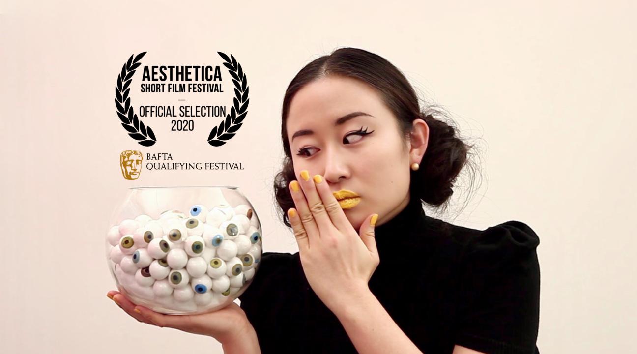 movie poster with woman holding bowl of fake eyeballs