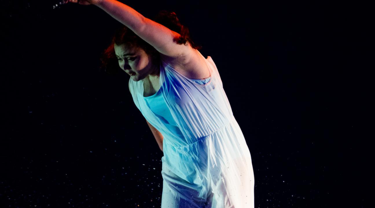 dancer splashing in water and wearing white