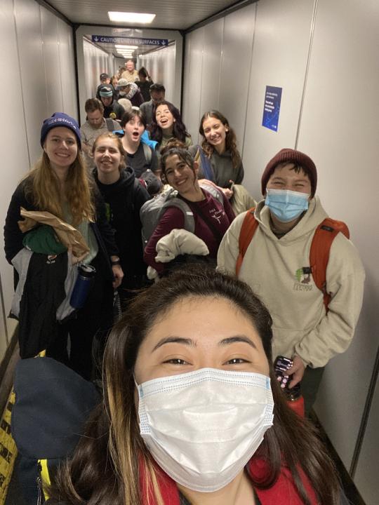 Farrah McAdam taking a selfie with dancers boarding airplane