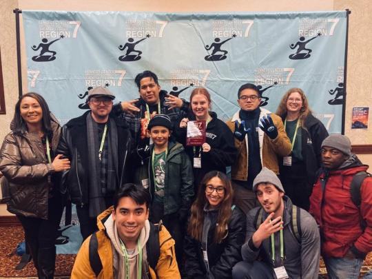 Group photo in front of banner