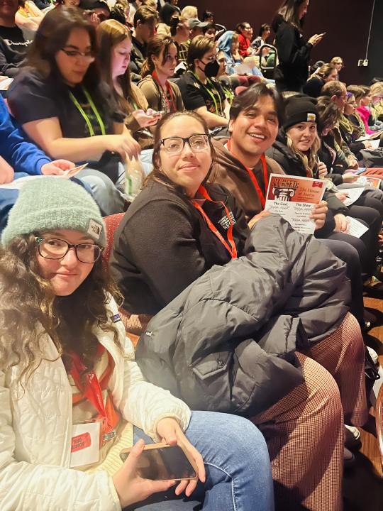 Students sitting in theatre seats