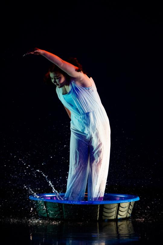 dancer splashing in water and wearing white