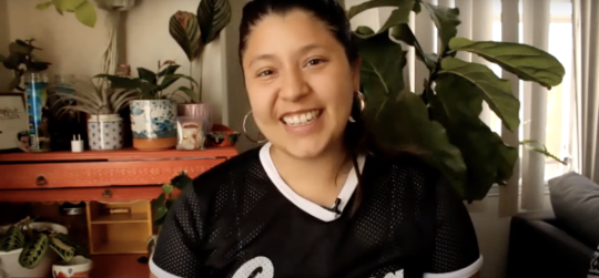 Screenshot of Noelle Dominique Rodriguez in her own home smiling