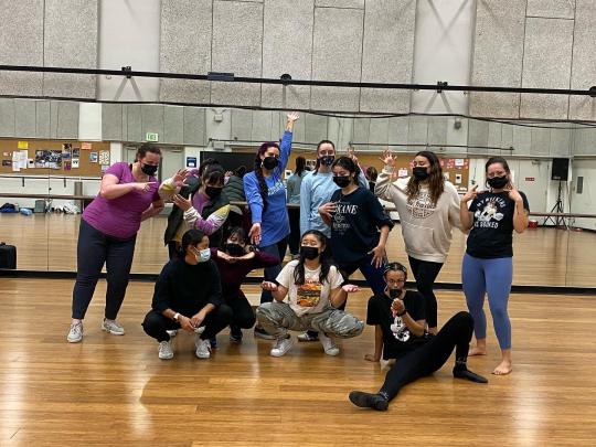 Vanessa Sanchez posing with dance students.